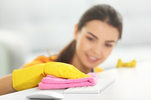 Spot cleaning stains on a living room sofa with a microfiber cloth